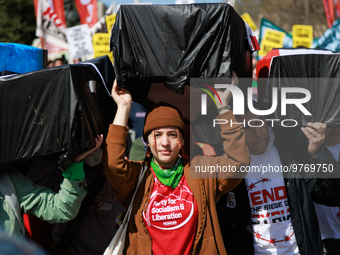 Demonstrators carry symbolic body caskets before placing them on the ground in front of the White House during an anti-war protest in Washin...