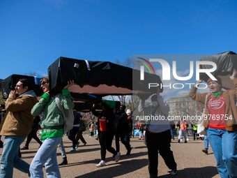 Demonstrators carry symbolic body caskets before placing them on the ground in front of the White House during an anti-war protest in Washin...