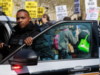 A United States Secret Service officer watches protestors during an anti-war protest in Washington, D.C. on March 18, 2023. The protest, org...