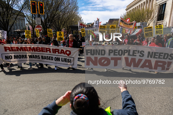 Demonstrators march in Washington, D.C. on March 18, 2023 during an anti-war protest organized by the Answer Coalition and dozens of other g...