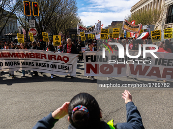 Demonstrators march in Washington, D.C. on March 18, 2023 during an anti-war protest organized by the Answer Coalition and dozens of other g...