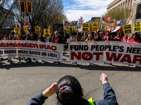 Demonstrators march in Washington, D.C. on March 18, 2023 during an anti-war protest organized by the Answer Coalition and dozens of other g...