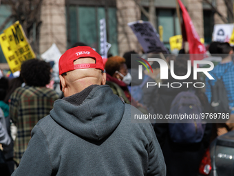 A person wears a hat bearing the name of former U.S. President Donald Trump as they watch an anti-war protest in Washington, D.C. on March 1...