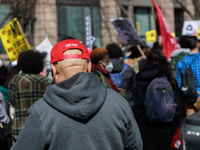 A person wears a hat bearing the name of former U.S. President Donald Trump as they watch an anti-war protest in Washington, D.C. on March 1...