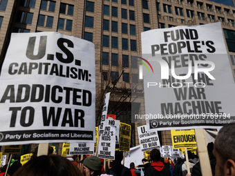 Demonstrators protest outside of the offices of The Washington Post in Washington, D.C. on March 18, 2023 during an anti-war march organized...