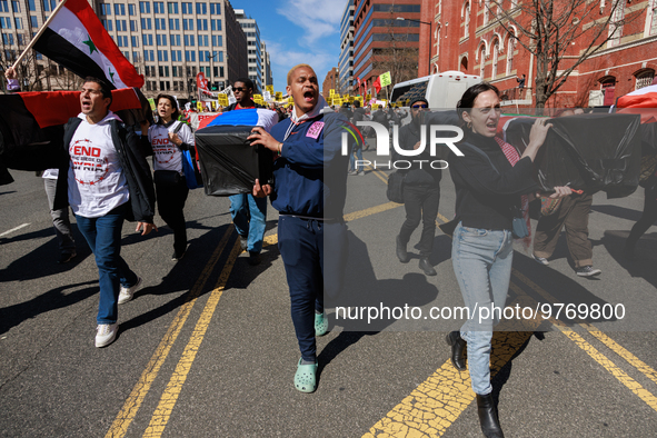 Demonstrators march in Washington, D.C. on March 18, 2023 during an anti-war protest organized by the Answer Coalition and dozens of other g...