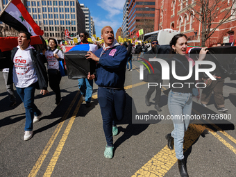 Demonstrators march in Washington, D.C. on March 18, 2023 during an anti-war protest organized by the Answer Coalition and dozens of other g...