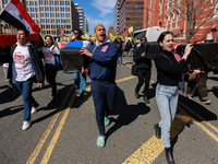 Demonstrators march in Washington, D.C. on March 18, 2023 during an anti-war protest organized by the Answer Coalition and dozens of other g...