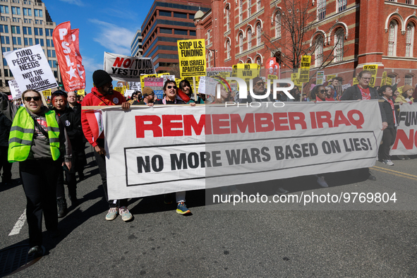 Demonstrators march in Washington, D.C. on March 18, 2023 during an anti-war protest organized by the Answer Coalition and dozens of other g...