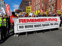 Demonstrators march in Washington, D.C. on March 18, 2023 during an anti-war protest organized by the Answer Coalition and dozens of other g...