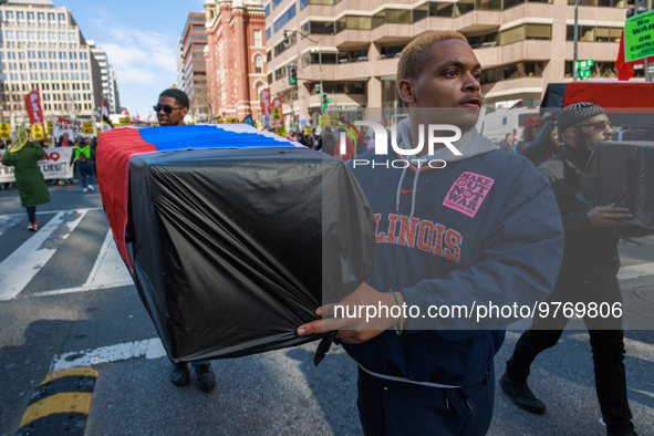 Demonstrators march in Washington, D.C. on March 18, 2023 during an anti-war protest organized by the Answer Coalition and dozens of other g...