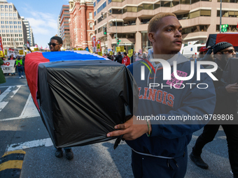 Demonstrators march in Washington, D.C. on March 18, 2023 during an anti-war protest organized by the Answer Coalition and dozens of other g...