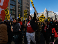 Demonstrators march in Washington, D.C. on March 18, 2023 during an anti-war protest organized by the Answer Coalition and dozens of other g...