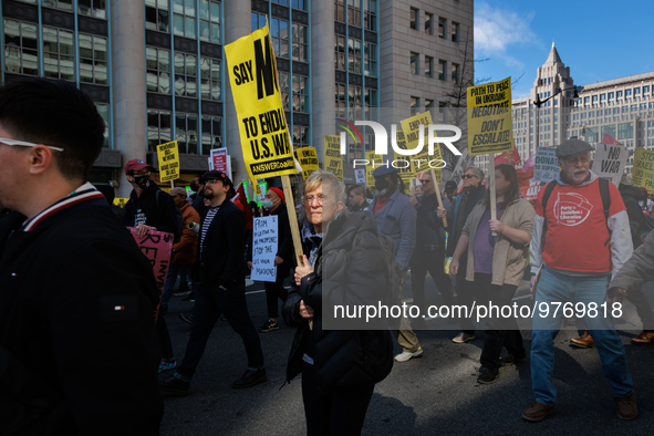 Demonstrators march in Washington, D.C. on March 18, 2023 during an anti-war protest organized by the Answer Coalition and dozens of other g...