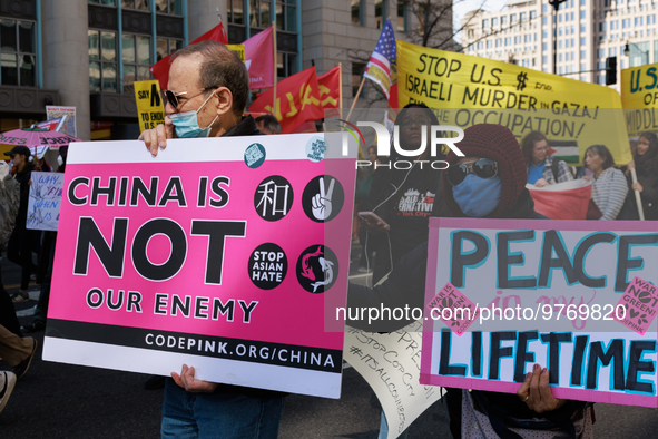 Demonstrators march in Washington, D.C. on March 18, 2023 during an anti-war protest organized by the Answer Coalition and dozens of other g...