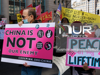 Demonstrators march in Washington, D.C. on March 18, 2023 during an anti-war protest organized by the Answer Coalition and dozens of other g...