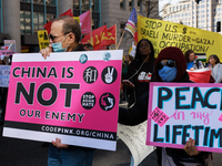 Demonstrators march in Washington, D.C. on March 18, 2023 during an anti-war protest organized by the Answer Coalition and dozens of other g...