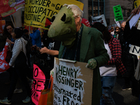 Demonstrators march in Washington, D.C. on March 18, 2023 during an anti-war protest organized by the Answer Coalition and dozens of other g...