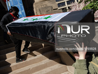 Demonstrators carry symbolic body caskets into The New York Avenue Presbyterian Church during an anti-war protest in Washington, D.C. on Mar...