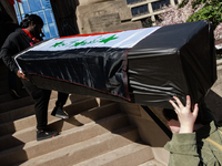 Demonstrators carry symbolic body caskets into The New York Avenue Presbyterian Church during an anti-war protest in Washington, D.C. on Mar...