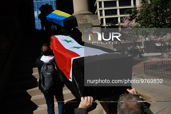 Demonstrators carry symbolic body caskets into The New York Avenue Presbyterian Church during an anti-war protest in Washington, D.C. on Mar...