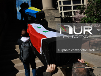 Demonstrators carry symbolic body caskets into The New York Avenue Presbyterian Church during an anti-war protest in Washington, D.C. on Mar...