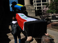 Demonstrators carry symbolic body caskets into The New York Avenue Presbyterian Church during an anti-war protest in Washington, D.C. on Mar...