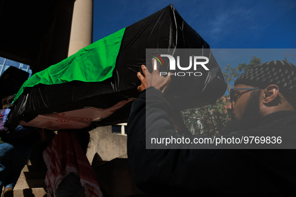 Demonstrators carry symbolic body caskets into The New York Avenue Presbyterian Church during an anti-war protest in Washington, D.C. on Mar...