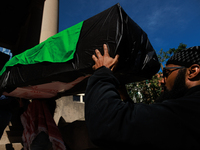 Demonstrators carry symbolic body caskets into The New York Avenue Presbyterian Church during an anti-war protest in Washington, D.C. on Mar...