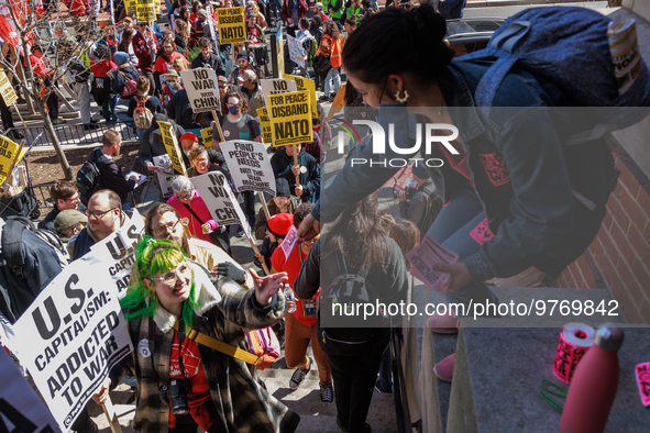 A woman hands out stickers as demonstrators walk into The New York Avenue Presbyterian Church to listen to people speak during an anti-war p...