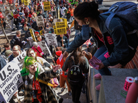 A woman hands out stickers as demonstrators walk into The New York Avenue Presbyterian Church to listen to people speak during an anti-war p...