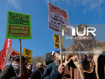 Demonstrators march in Washington, D.C. on March 18, 2023 during an anti-war protest organized by the Answer Coalition and dozens of other g...