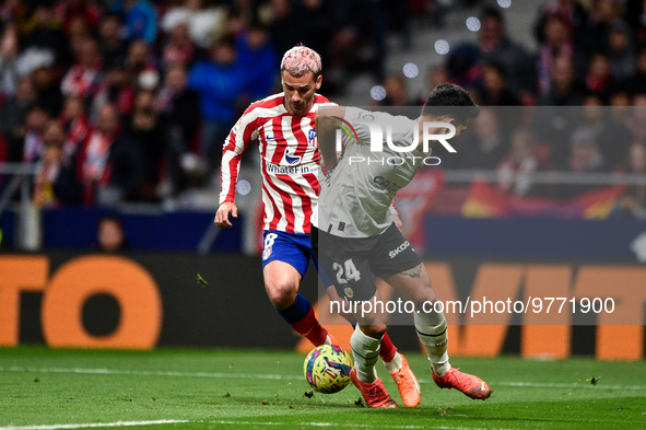 Antoine Griezmann and Eray Comert during La Liga match between Atletico de Madrid and Valencia CF at Civitas Metropolitano on March 18, 2023...