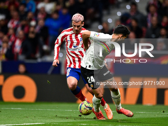 Antoine Griezmann and Eray Comert during La Liga match between Atletico de Madrid and Valencia CF at Civitas Metropolitano on March 18, 2023...