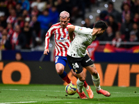 Antoine Griezmann and Eray Comert during La Liga match between Atletico de Madrid and Valencia CF at Civitas Metropolitano on March 18, 2023...