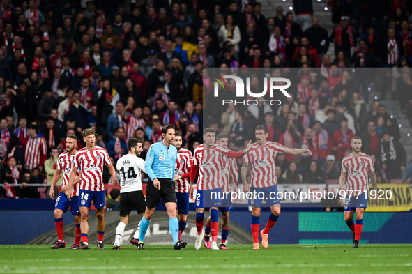 Munuera Montero, Josema Gimenez and Stefan Savic during La Liga match between Atletico de Madrid and Valencia CF at Civitas Metropolitano on...