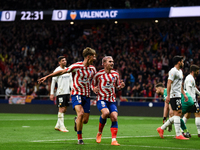 Marcos Llorente and Antoine Griezmann celebrates a goal during La Liga match between Atletico de Madrid and Valencia CF at Civitas Metropoli...