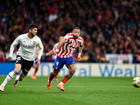 Memphis Depay and Cenk Ozkacar during La Liga match between Atletico de Madrid and Valencia CF at Civitas Metropolitano on March 18, 2023 in...