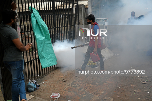 An employee of Dhaka south City Corporation sprays pesticide for kill mosquitoes in Dhaka, Bangladesh on March 19, 2023 