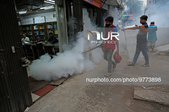 An employee of Dhaka south City Corporation sprays pesticide for kill mosquitoes in Dhaka, Bangladesh on March 19, 2023 