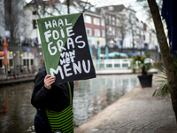 Activist at the entrance of a restaurant that serves foie gras, in Utrecht, Netherlands, on March 18, 2023.  (