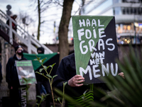 Activists at the entrance of a restaurant that serves foie gras, in Utrecht, Netherlands, on March 18, 2023.  (