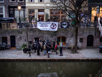 Activists at the entrance of a restaurant that serves foie gras, in Utrecht, Netherlands, on March 18, 2023.  (