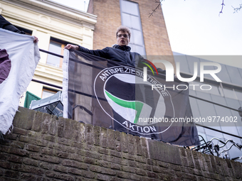 Activist at the top of the moat above a restaurant that serves foie gras, in Utrecht, Netherlands, on March 18, 2023.  (