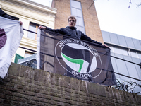 Activist at the top of the moat above a restaurant that serves foie gras, in Utrecht, Netherlands, on March 18, 2023.  (