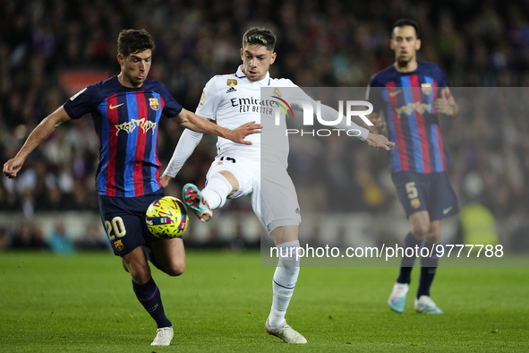 Federico Valverde central midfield of Real Madrid and Uruguay and Sergi Roberto right-back of Barcelona and Spain compete for the ball durin...