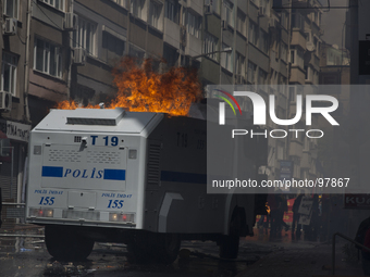 A police water cannon caught fire after being hit by a molotov cocktail. Protestors affected by tear gas during clashes with police on May D...