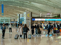 Passengers with luggages walk and wait check-in at Incheon International Airport on March 30, 2023, South Korea.
According to Incheon Intern...