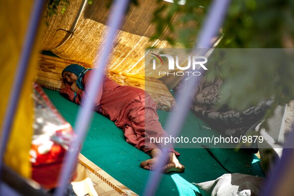 A refugee women who sleeps in an improvised space inside the Qushtepa Park Camp near Erbil. The people there living like prisoners and need...