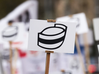 A banner with a symbol of nurse's cap is seen during a protest of Polish nurses and midwives of hospitals from all the country in Krakow, Po...